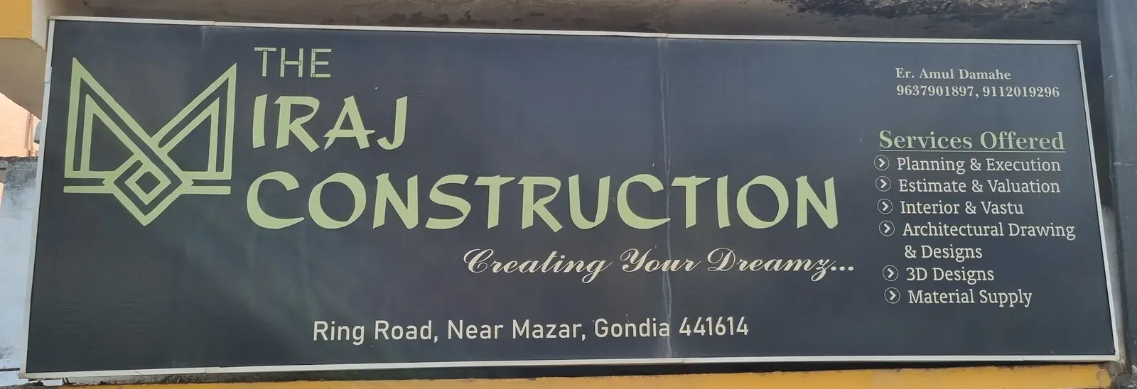 The Miraj Construction signboard: green M logo on black, list of services and phone numbers